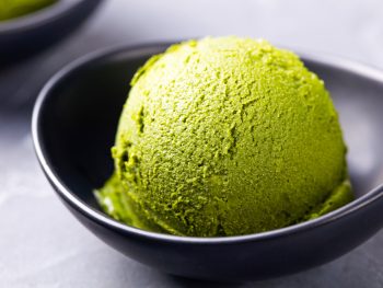 scoop of vegan matcha ice cream in a black bowl