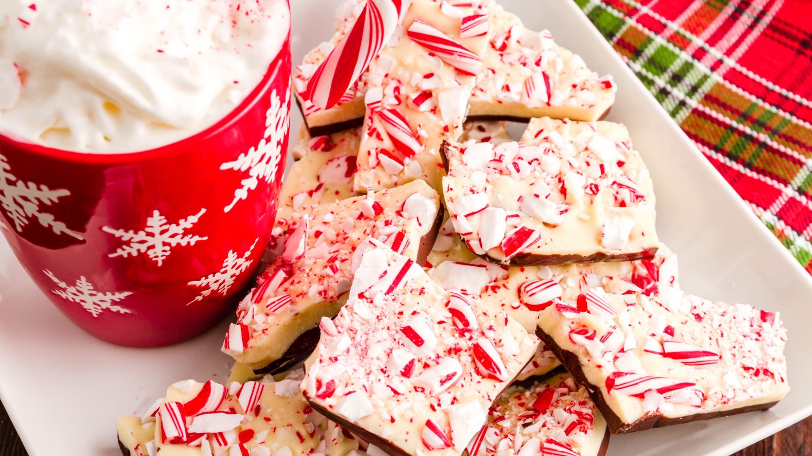 vegan peppermint bark on a plate with a red mug