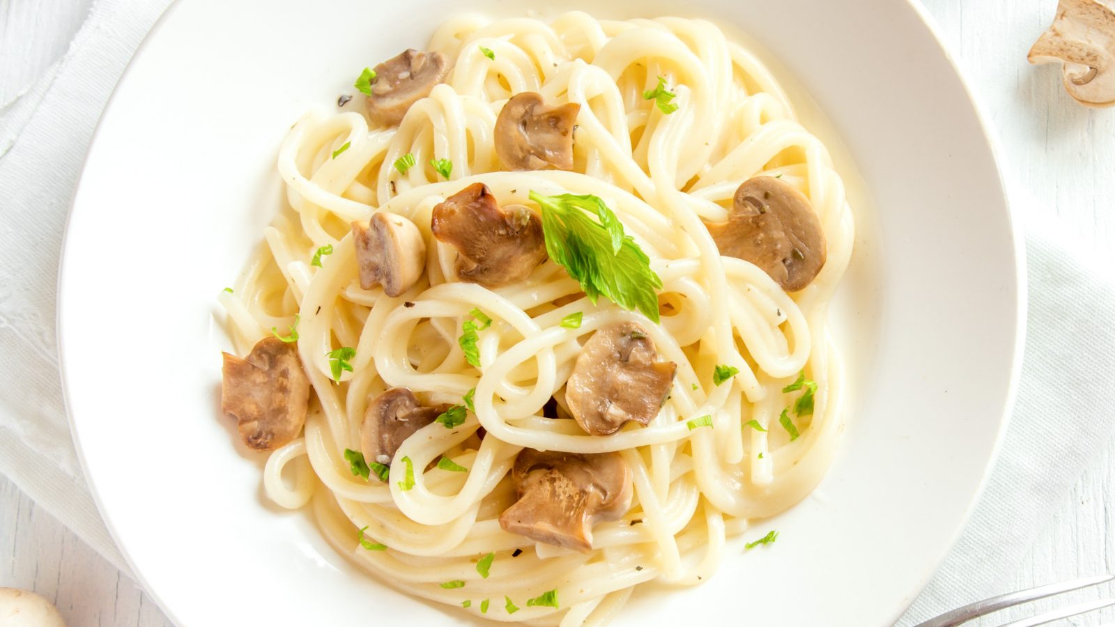 creamy mushroom pasta recipe in a bowl from above with parsley as garnish