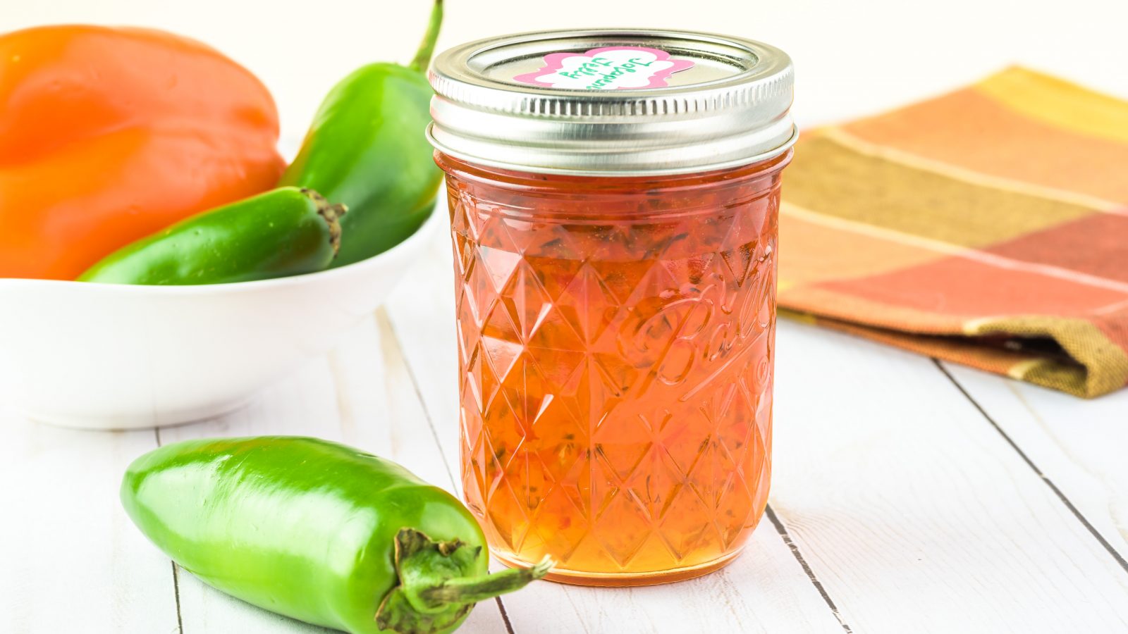 jalapeno jelly with peppers in the background