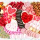 close up of a valentines day charcuterie board with cookies and candy