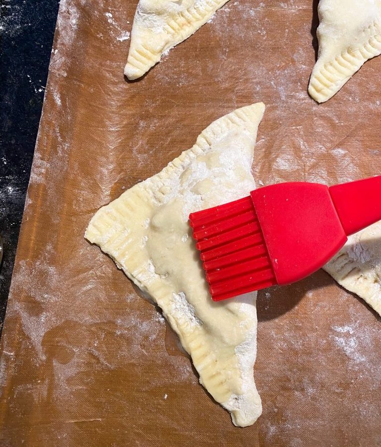 painting an apple turnover with a vegan egg wash substitute