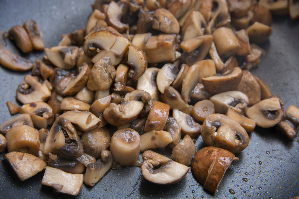 Pile of chopped mini bella mushrooms.
