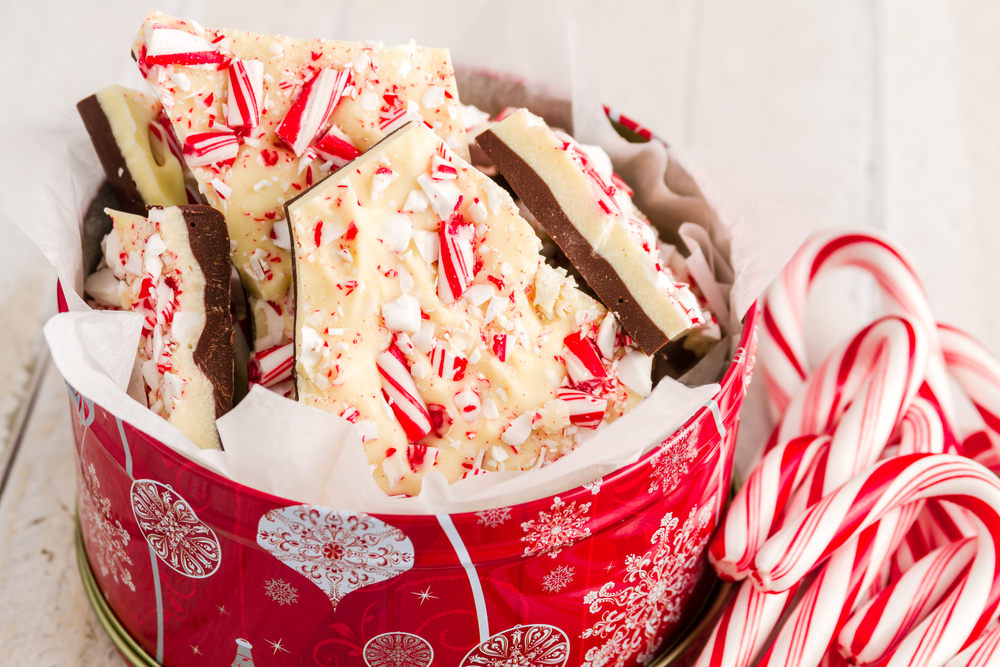 Homemade vegan peppermint bark packaged in clear bag with red ribbon for holiday gifting