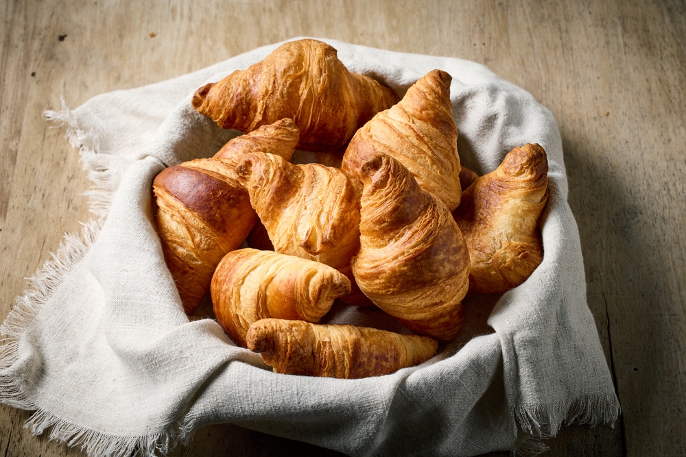 freshly baked croissants on wooden rustic kitchen table