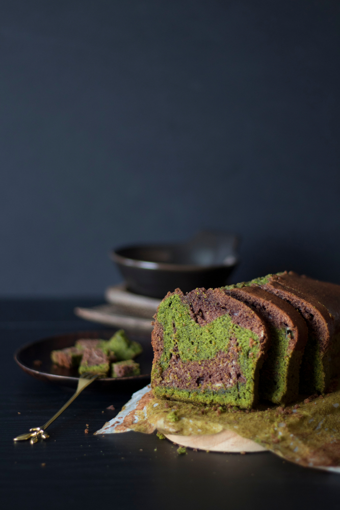 Chocolate Green Tea Cake shot against Black background.  Matcha Cake on a wooden board. 