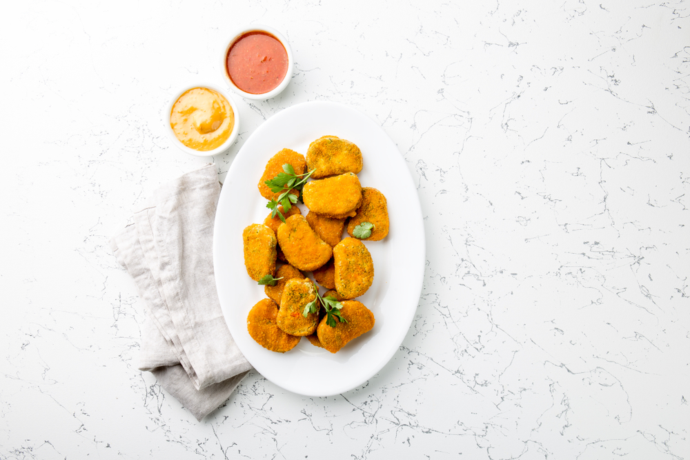Healthy vegetarian nuggets with carrots, cauliflower and spinach. Vegetable nuggets. Vegan food. Top view, white background.