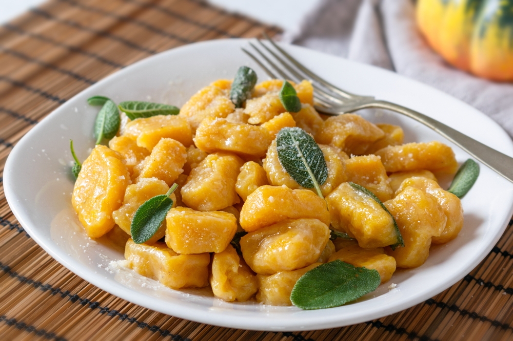Pumpkin Gnocchi with and sage, on a white plate