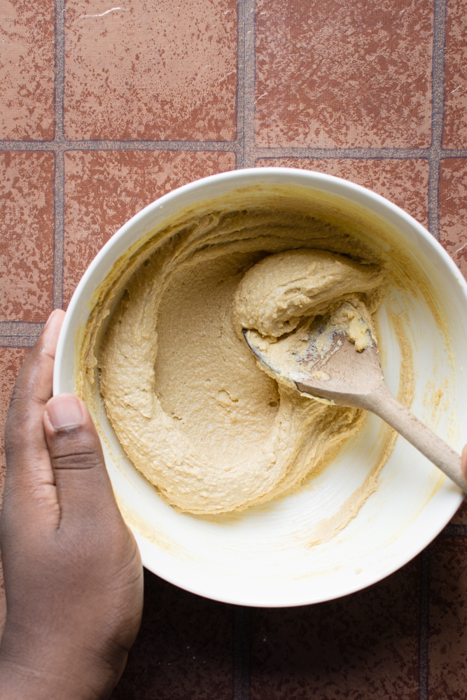 Creaming butter and sugar with a wooden spoon, the process of making a cake, mixing butter and sugar to make  cookies